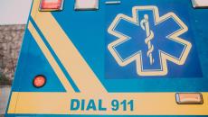 The back of an ambulance painted with a medical symbol and the words "Call 911"