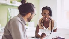 Person talking to doctor pointing at tablet