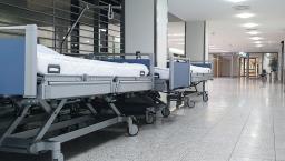 Hospital beds parked in a corridor
