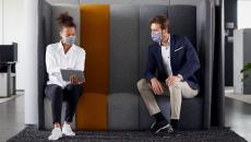 People examine tablet in office meeting