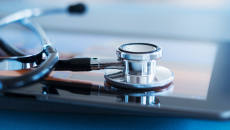 Stethoscope resting on a tablet